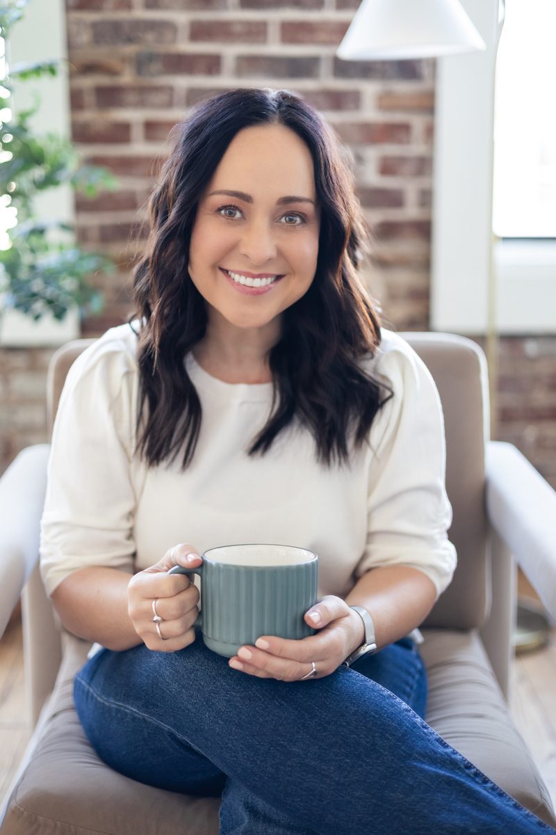 Sara Stockinger seated with a teal mug